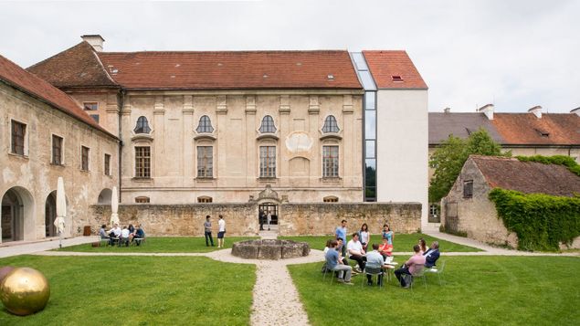 Tagungsgäste unterhalten sich im barocken Prälatengarten des TUM Akademiezentrums Raitenhaslach