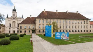 The facade of the TUM Science & Study Center with TUM150 anniversary branding.